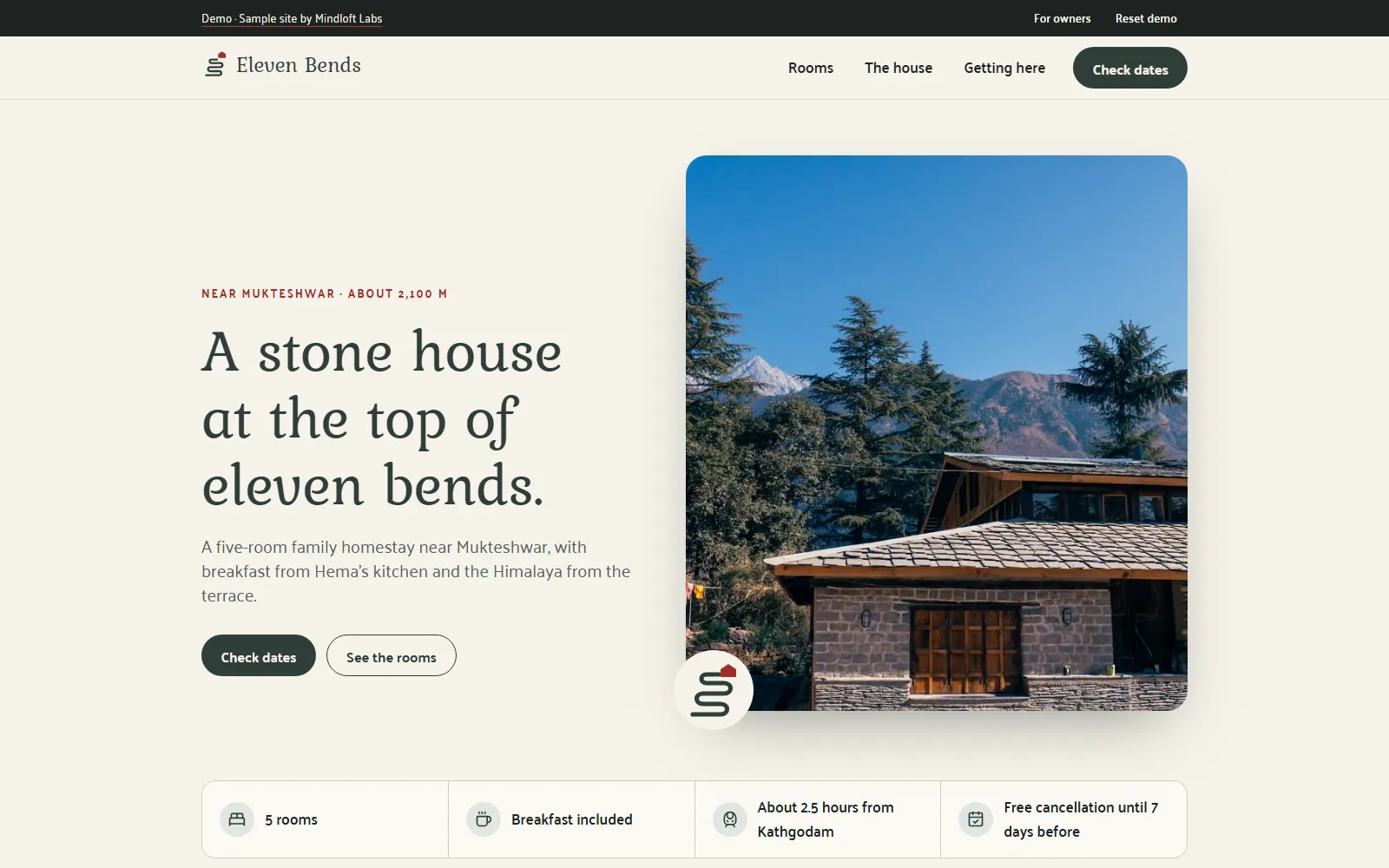 The home page of the Eleven Bends demo site, with the heading "A stone house at the top of eleven bends.", a stone and timber house below snowy peaks and a "Check dates" button.
